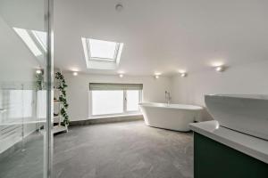 a white bathroom with a tub and a sink at 2 Bed in Llanarthney oc-c28877 in Llanarthney +12 photos