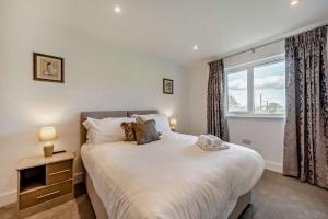 a bedroom with a large bed and a window at 2 Bed in Llanarthney oc-c28877 in Llanarthney