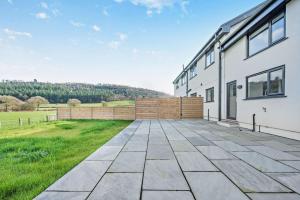 an empty patio next to a white building at 2 Bed in Llanarthney oc-c28877 in Llanarthney