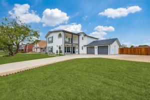 a large white house with a grass yard at LWV Dallas Social - Lakewood Village in Little Elm