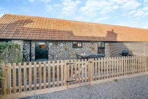 a house with a wooden fence in front of it at 2 Bed in Clevedon oc-t30786 in Clevedon