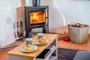 two cups of coffee on a table in front of a fireplace at 2 Bed in Clevedon oc-t30786 in Clevedon +8 photos