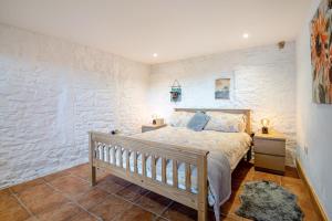 a bedroom with a bed and a stone wall at 2 Bed in Clevedon oc-t30786 in Clevedon