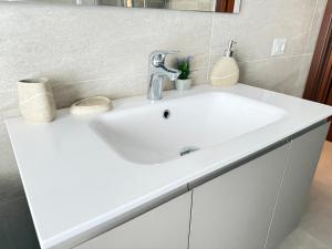 a bathroom with a white sink and a mirror at Vittorio city apartment, Milano, Centro in Melzo