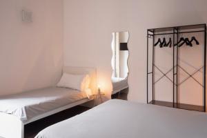 a room with two beds and a lamp in it at B&B Università in Catania