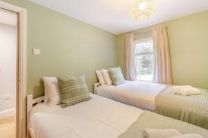 a bedroom with two beds and a mirror at 3 Bed in Cromford oc-t30751 in Cromford