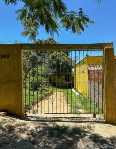 an open gate with a playground behind it at Casinha Charmosa in Miguel Pereira