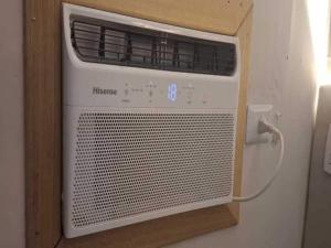 a white heater on a wall in a room at Casinha Charmosa in Miguel Pereira