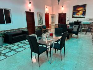 a dining room with a glass table and chairs at Colonial Hotel Boutique by VBermor in Santo Domingo