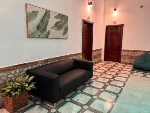 a living room with a couch and a picture on the wall at Colonial Hotel Boutique by VBermor in Santo Domingo