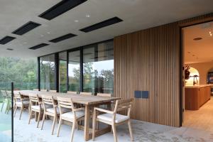 a dining room with a wooden table and chairs at Tarida Durbuy in Durbuy