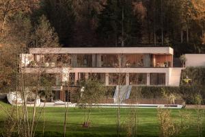 a large white building with trees in front of it at Tarida Durbuy in Durbuy