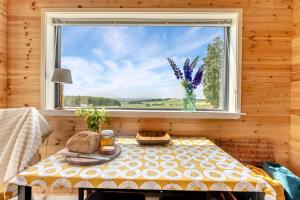 a table in a room with a window with a vase of flowers at 2 Bed in Strathmiglo oc-w32098 in Strathmiglo +22 photos