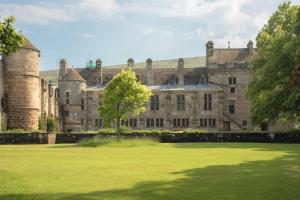 an old castle with a grass field in front of it at 2 Bed in Strathmiglo oc-w32098 in Strathmiglo