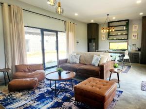 a living room with a couch and a table at The Zain's Pool Villa for 4 pax, Langkawi in Ulu Melaka