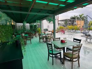 an outdoor patio with tables and chairs at Colonial Hotel Boutique by VBermor in Santo Domingo