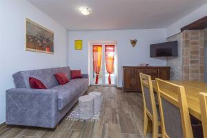 a living room with a couch and a dining room table at Casa Mia By Kompas Villas in Butkovići