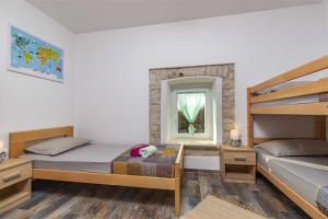 a bedroom with two bunk beds and a window at Casa Mia By Kompas Villas in Butkovići +31 photos