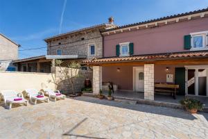 a house with two chairs and a patio at Casa Mia By Kompas Villas in Butkovići