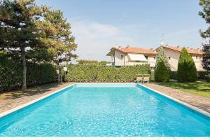 a swimming pool in the backyard of a house at Appartamento Di Morgana Sirmione in Sirmione