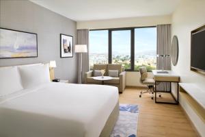 a hotel room with a bed and a desk at Crowne Plaza Muscat by IHG in Muscat +120 photos