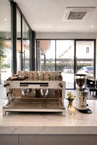 a kitchen with a coffee machine on a counter at โรงแรมแซนด์บอกซ์ นครศรีธรรมราช in Nakhon Si Thammarat