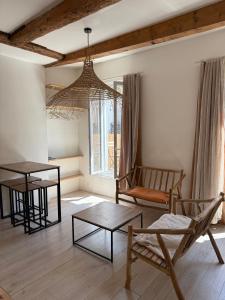 a living room with a chandelier and a table and chairs at LaFrenchCasa Canebière in Marseille +23 photos