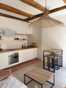 a kitchen with white cabinets and a table at LaFrenchCasa Canebière in Marseille