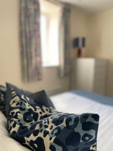 a bed with black and white pillows in a bedroom at Martindales Yard in Kendal