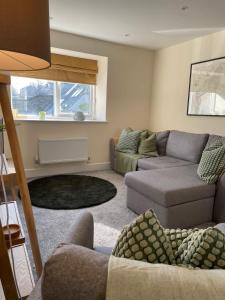 a living room with a couch and two couches at Martindales Yard in Kendal