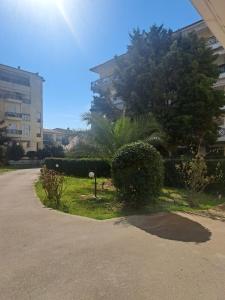 a street with some bushes and trees and buildings at Nana apartment in Perea
