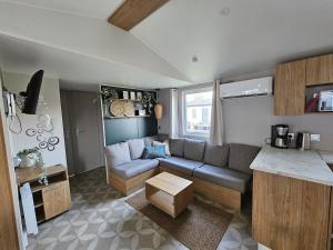 a living room with a couch and a table at Eekhoorn 7 in Gasselte
