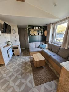 a living room with a couch and a table at Eekhoorn 7 in Gasselte