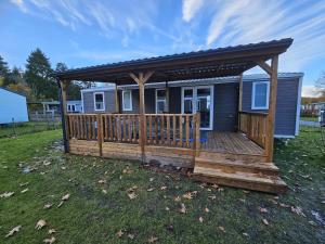 a house with a wooden deck with a gazebo at Eekhoorn 7 in Gasselte