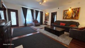 a living room with a couch and a table at Kytila Apartments in Chitila