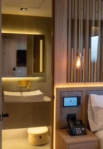 a hotel room with a telephone and a sink at Punto Suites Periférico Sur in Mexico City +147 photos