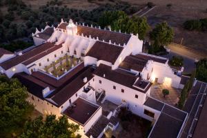 an aerial view of a large white mansion at Convento do Espinheiro, Historic Hotel & Spa in Évora