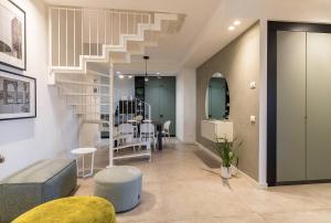 a living room with a staircase and a table at Appartamento Di Morgana Sirmione in Sirmione
