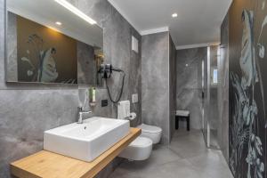 a bathroom with a sink and a toilet at Pier Hotel in Andalo +88 photos