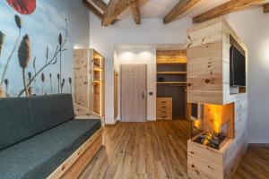 a living room with a fireplace and a couch at Pier Hotel in Andalo