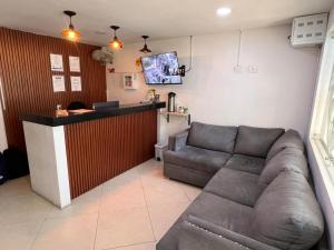 a living room with a couch and a bar at Hotel Casa Florida 70 Medellin in Medellín