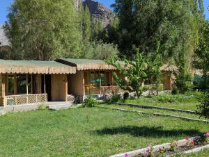 a house in a field with a yard at The Sylvan Hut in Leh