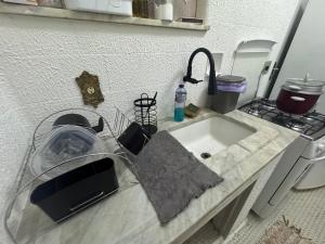 a kitchen counter top with a sink and a sink at Apartamento alto de Teresópolis in Teresópolis +10 photos