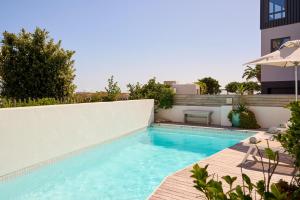 a swimming pool on the side of a building at ocean10 Guesthouse in Cape Town