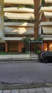 a car parked in front of a tall building at Fotini apartment in Agrinio +2 photos