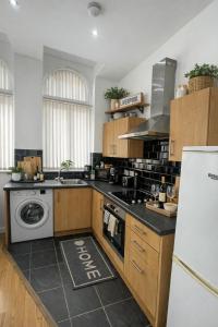 a kitchen with a sink and a stove top oven at City Centre stay in Liverpool