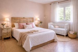 a bedroom with a large bed and a crib at Casa rural "Garnacha de Borja" guest home in Borja +89 photos