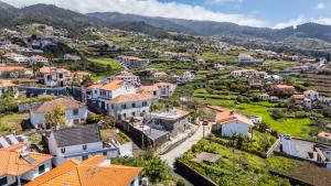 an aerial view of a town with houses at Social Lodge Galinho House - Sea View - Calheta in Estreito da Calheta +17 photos