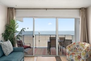 a living room with a view of the ocean at El Capitan 206 - Dolphin Watch in Ocean City