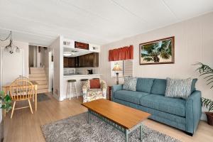 a living room with a blue couch and a table at El Capitan 206 - Dolphin Watch in Ocean City